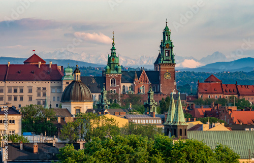 Wawel castle during colorful sunset with snowy Tatra mountains in the background, Krakow, Poland