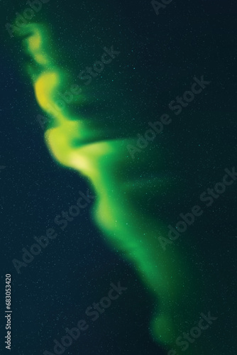 Green aurora borealis. Dark night starry sky and bright polar lights