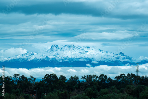 Mexican volcano Iztaccihuatl with snow since mexico city near of Xochimilco photo