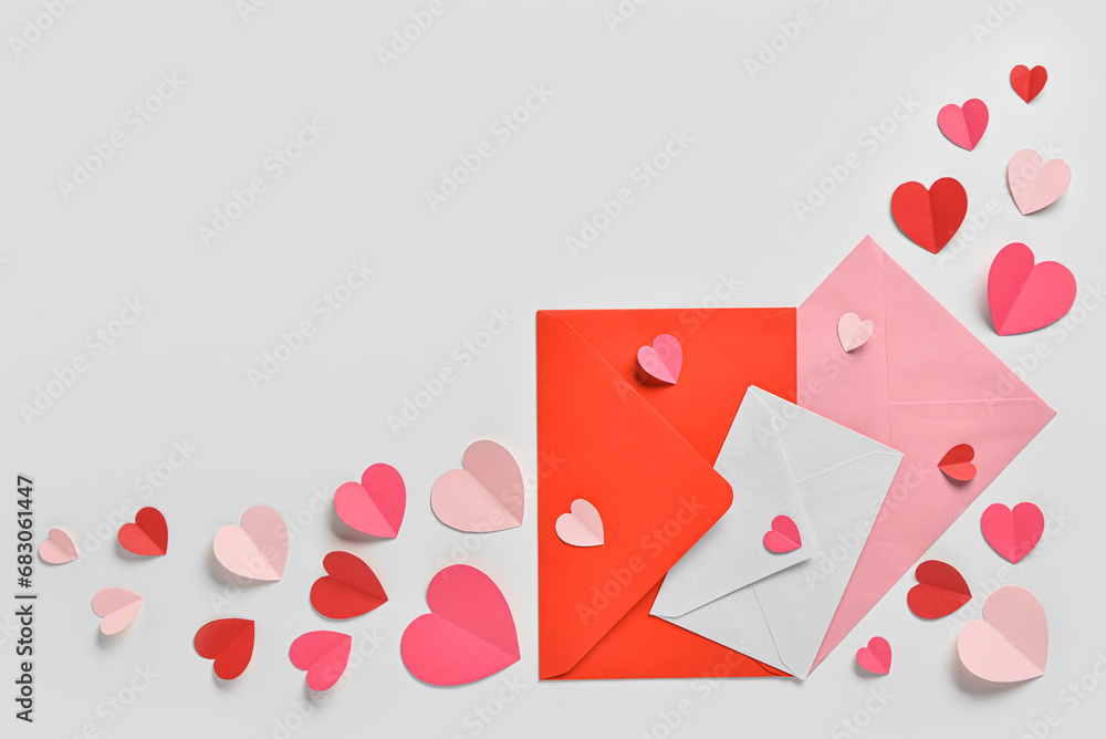Romantic composition with postcard, red and pink paper hearts on white background. St. Valentine's Day. Romantic composition with postcard, red and pink paper hearts on white background. St. Valentine's Day.