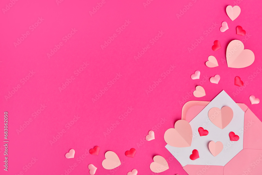 Composition with different paper hearts and envelope on pink background