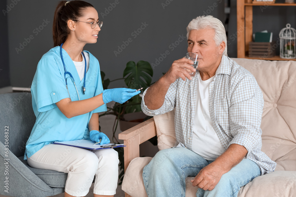 Obraz premium Senior man with nurse at home