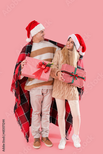 Happy young couple in santa...