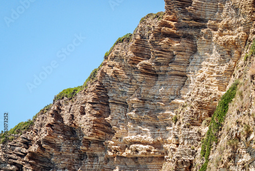 Rocks seen from boat next to Chomi beach known as Paradise beach near Palaiokastritsa village on Corfu Island, Greece photo