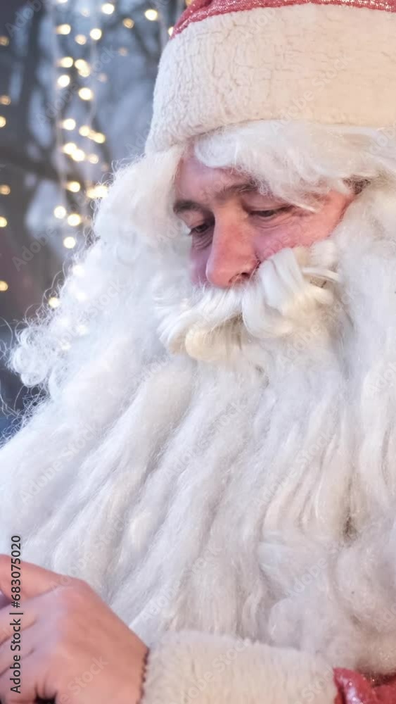 Santa Claus is using a smartphone. Vertical video Santa Claus is using a smartphone. Vertical video