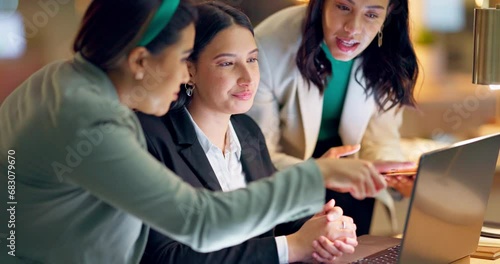 Laptop, collaboration and business women in the office together for research, ideas or discussion. Technology, teamwork and explain with a happy young employee group talking in the workplace at night