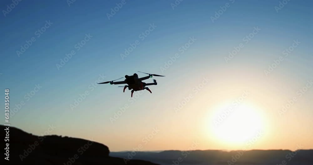 Drone flying against sunset sky Drone flying against sunset sky