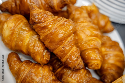 Croissants on a white plate, close-up, selective focus