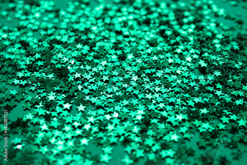Green Shiny Star shaped confetti texture background. Abstract Christmas twinkle scattering stars confetti background.