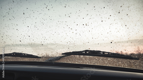 Drops of dirt on the windshield of a car. Autumn landscape through the windshield of a car