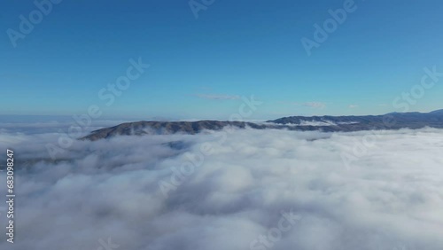 Wallpaper Mural Flying over clouds and mountain hills. View from a drone Torontodigital.ca