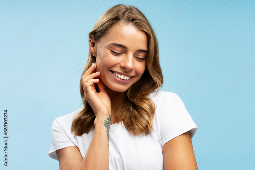 Portrait of smiling modern hipster woman with silky wavy hair wearing white t shirt posing Portrait of smiling modern hipster woman with silky wavy hair wearing white t shirt posing