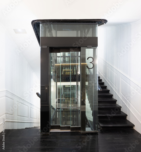 Glass elevator in lobby of modern residential photo