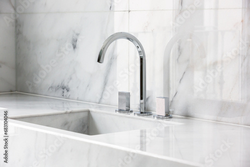 Steel faucet with knobs at kitchen sink photo