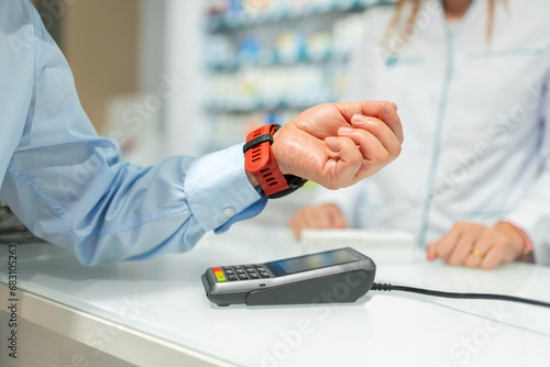 Man scanning smartwatch over machine and paying in store photo
