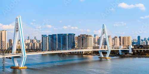 High angle view of the Century Bridge over the Haidian River in Haikou, Hainan, China, on a sunny day photo