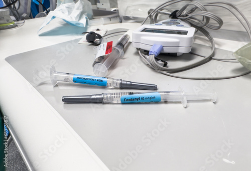 Clinical setting with medications, syringes, and needles on a hospital tray, symbolizing healthcare and treatment photo