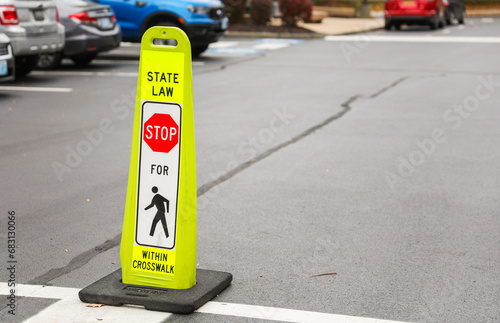 Pedestrian sign on bustling city street guiding pedestrians safely across, urban safety concept