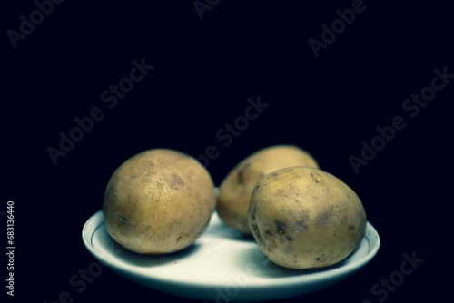 Close-up of potato on table,Close-up of potato against wall in darkroom,basket with fresh potatoes,Basket with fresh potatoes,Crop peruvian farmer in bright traditional costume showing heap of freshly