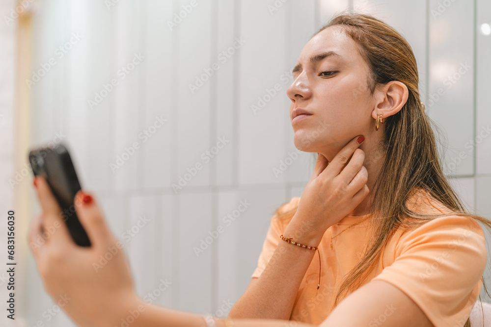Young woman dissatisfied with her double chin Young woman dissatisfied with her double chin