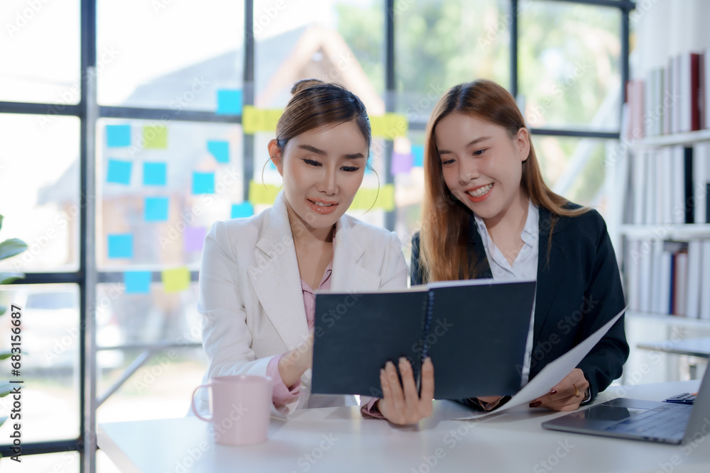 Two Asian business woman are talking and consulting at office. Two Asian business woman are talking and consulting at office.