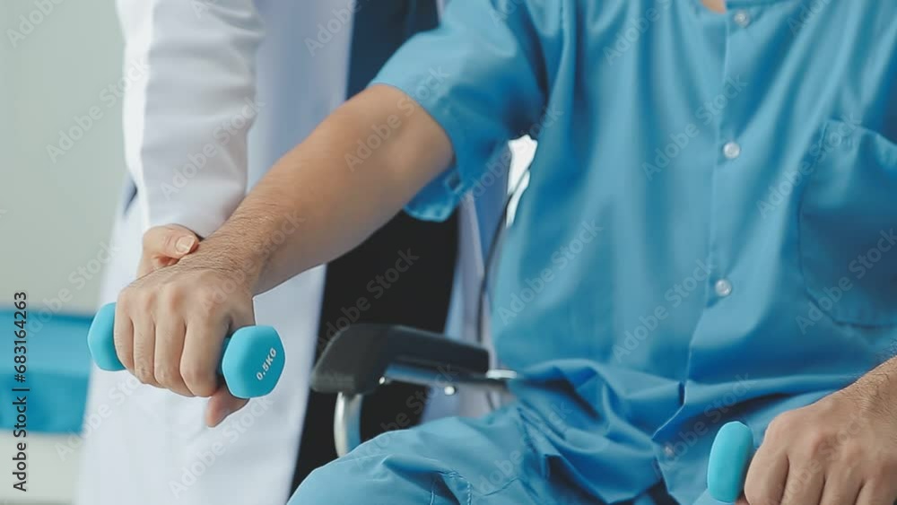 Physiotherapist man giving exercise with dumbbell treatment About Arm and Shoulder of athlete male patient Physical therapy concept Physiotherapist man giving exercise with dumbbell treatment About Arm and Shoulder of athlete male patient Physical therapy concept