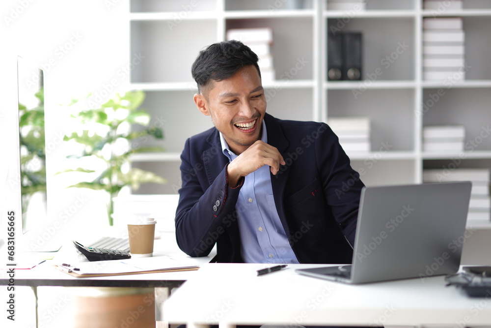Businessman working with laptop on desk in office. Businessman working with laptop on desk in office.