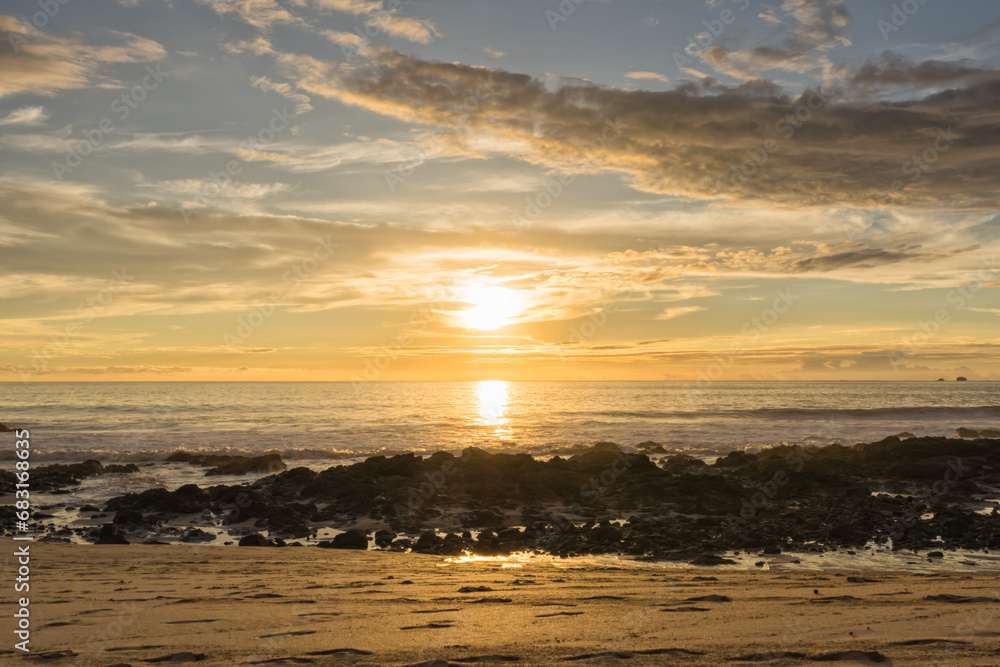Golden Sunset over a Rocky Beach