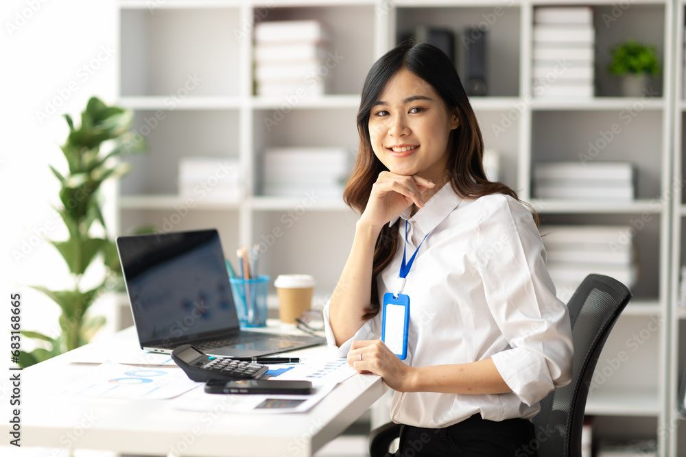 Portrait of a charming female employee working in the office. Portrait of a charming female employee working in the office.