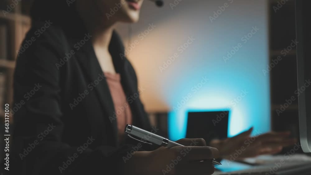 Young woman working in call centre, surrounded by colleagues Young woman working in call centre, surrounded by colleagues