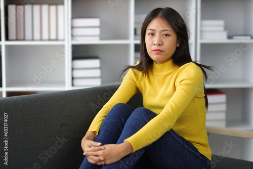 Young Asian woman with sickness and fever sitting on sofa at home. Young woman with depressed, depressed, worried and stressed. Free Download Young Asian woman with sickness and fever sitting on sofa at home. Young woman with depressed, depressed, worried and stressed. - GFXLoad