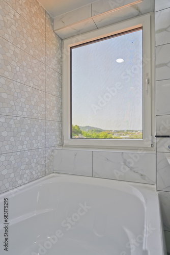 A large window was placed in front of the bathtub  creating a romantic space where you can view the outside environment
