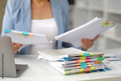 Senior businesswoman is stressed from doing too much paperwork.