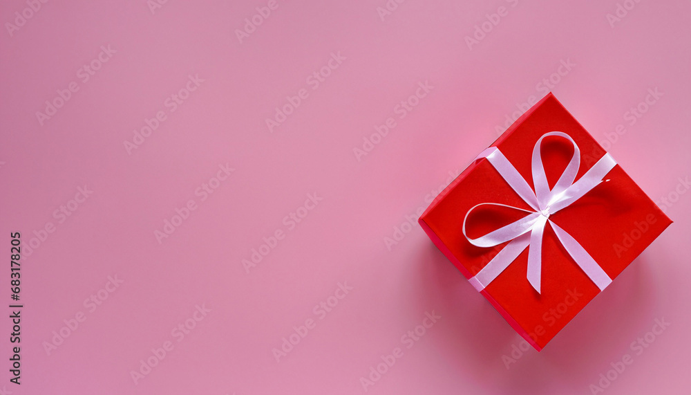 Red gift box on pink background. February 14 card, Valentine's day. 8 March, International Happy Women's Day. Flat lay, top view, copy space Red gift box on pink background. February 14 card, Valentine's day. 8 March, International Happy Women's Day. Flat lay, top view, copy space
