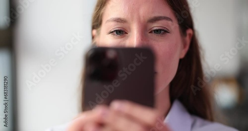 Closeup of woman addicted to smartphone photo