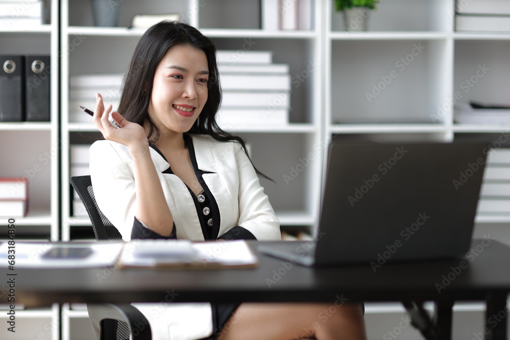 Portrait of attractive Asian businesswoman working with laptop in office. Portrait of attractive Asian businesswoman working with laptop in office.