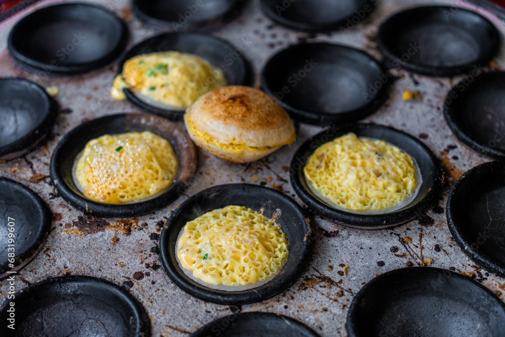 Vietnamese Street Food in Da Lat city, Vietnam - Banh can on the warm ember stove kitchen. Food and travel concept. Vietnamese Street Food in Da Lat city, Vietnam - Banh can on the warm ember stove kitchen. Food and travel concept.