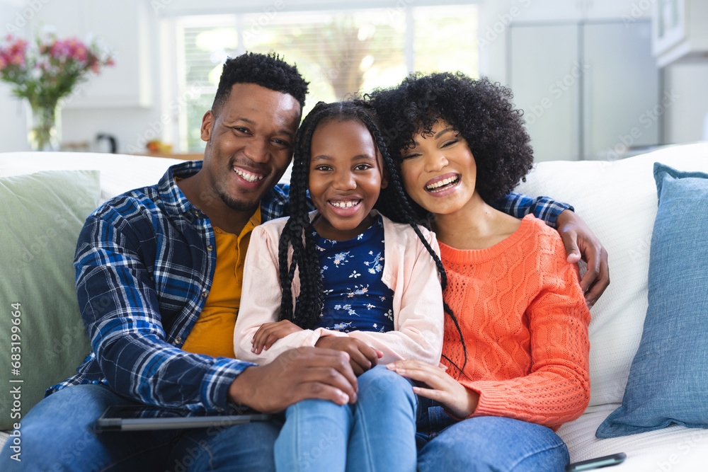 Portrait of happy african american family sitting on couch at home, copy space Portrait of happy african american family sitting on couch at home, copy space
