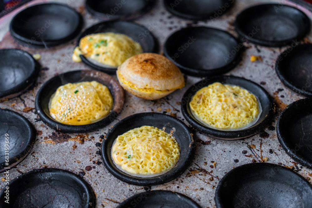 Vietnamese Street Food in Da Lat city, Vietnam - Banh can on the warm ember stove kitchen. Food and travel concept. Vietnamese Street Food in Da Lat city, Vietnam - Banh can on the warm ember stove kitchen. Food and travel concept.