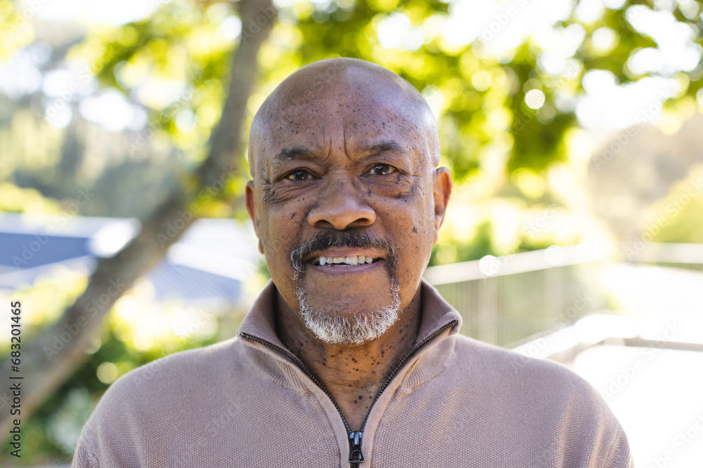 Portrait of african american senior man on sunny terrace Portrait of african american senior man on sunny terrace