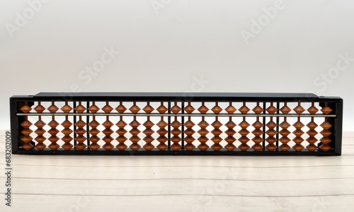 Chinese Abacus. Ancient calculator. Wooden background photo