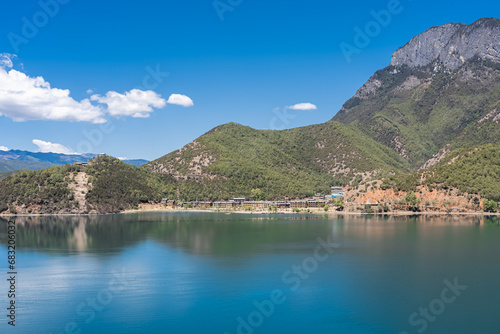 Fototapeta Naklejka Na Ścianę i Meble -  The reflection of blue sky and white clouds on the water surface of Lugu Lake in China
