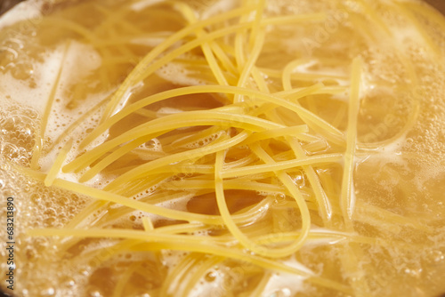 Boil pasta noodles in boiling water