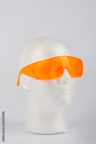 Clear plastic safety goggles isolated on white background photo