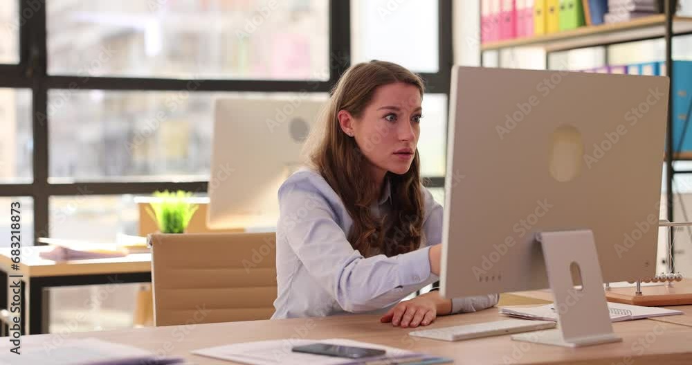 Young beautiful woman looking at laptop computer in office, disappointed and shocked and reading bad news on Internet Young beautiful woman looking at laptop computer in office, disappointed and shocked and reading bad news on Internet