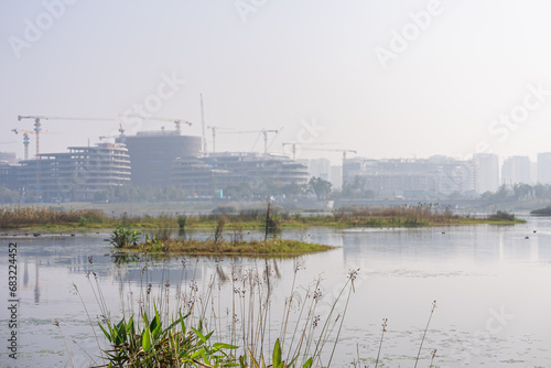 High rise buildings under construction by the lakeside