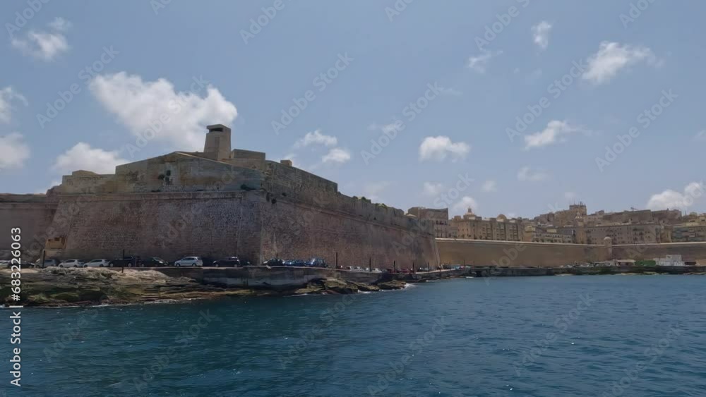Boat tour off the coast of Malta, Valletta overlooking pier with historical building Boat tour off the coast of Malta, Valletta overlooking pier with historical building