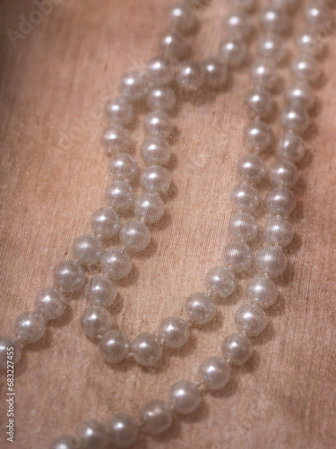 Pearl necklace under beige silk fabric