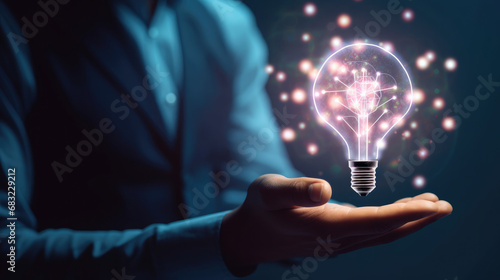 Businessman holding half of virtual lightbulb and brain on blue bokeh background , Smart thinking idea and inspiration innovation concept. blu background
