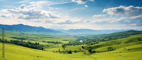 Beautiful landscape with green meadows and blue sky with clouds.